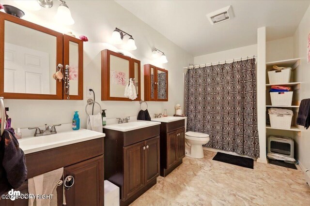 4588 Gold Mint Dr, Wasilla, AK 99654 - full bath featuring two vanities, toilet, and curtained shower