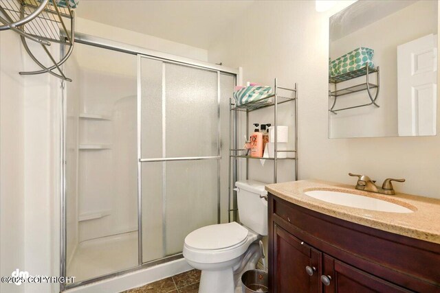 4588 Gold Mint Dr, Wasilla, AK 99654 - full bath featuring a shower stall, toilet, vanity, and tile patterned floors
