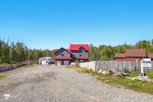 4588 Gold Mint Dr, Wasilla, AK 99654 - view of front of property featuring a garage, metal roof, and gravel driveway