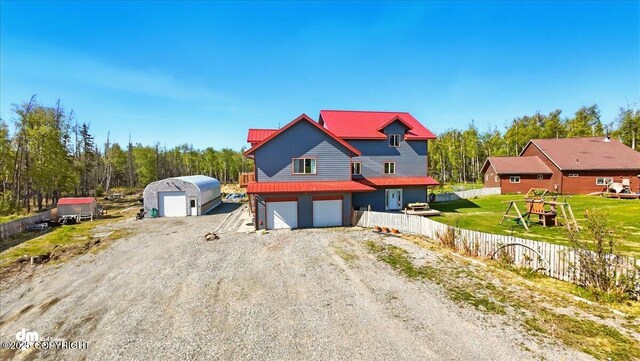 4588 Gold Mint Dr, Wasilla, AK 99654 - view of front of home featuring metal roof, an attached garage, and driveway