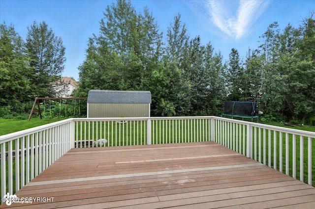 2213 N Tabasco Cat Dr, Palmer, AK 99645 - deck featuring a trampoline, a storage unit, and a yard