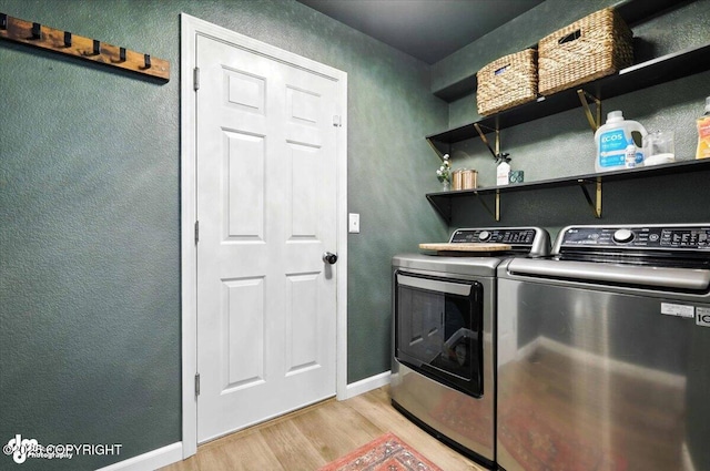 2213 N Tabasco Cat Dr, Palmer, AK 99645 - laundry room with light wood-type flooring, washer and dryer, and a textured wall