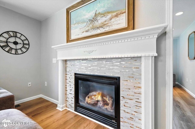 2213 N Tabasco Cat Dr, Palmer, AK 99645 - detailed view of wood finished floors, a tiled fireplace, and recessed lighting
