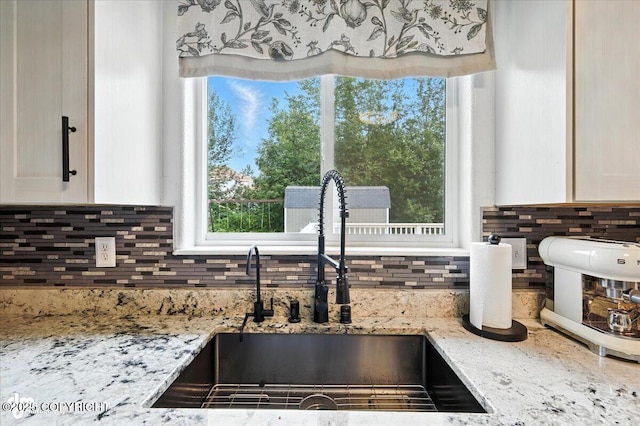 2213 N Tabasco Cat Dr, Palmer, AK 99645 - kitchen view of backsplash, light stone counters, and white cabinetry