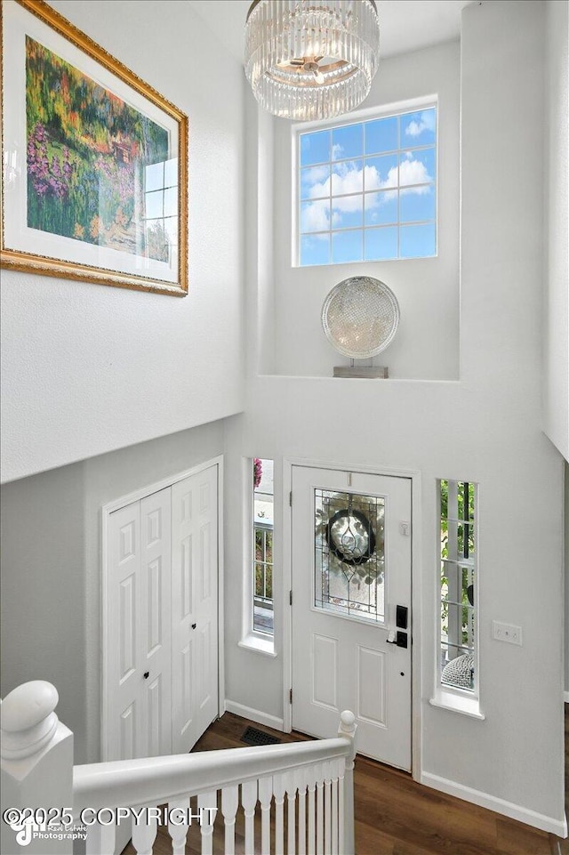 2213 N Tabasco Cat Dr, Palmer, AK 99645 - entryway with a chandelier, dark wood-style floors, plenty of natural light, and a towering ceiling