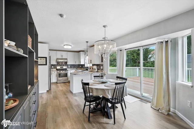 2213 N Tabasco Cat Dr, Palmer, AK 99645 - dining space featuring a chandelier and light wood finished floors