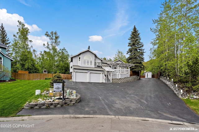 10931 Adanak Cir, Eagle River, AK 99577 - view of front of home with an attached garage, asphalt driveway, and stairway