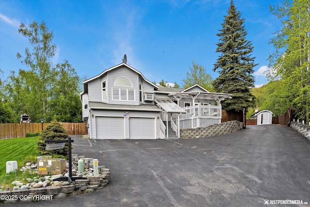 10931 Adanak Cir, Eagle River, AK 99577 - view of front of home with asphalt driveway and a garage