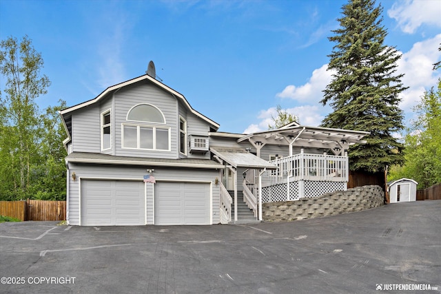 10931 Adanak Cir, Eagle River, AK 99577 - view of front facade featuring asphalt driveway, a garage, and stairway