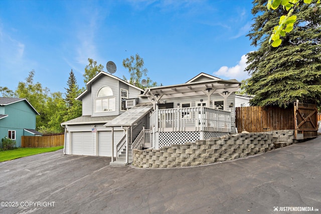 10931 Adanak Cir, Eagle River, AK 99577 - view of front of house with an attached garage, asphalt driveway, a porch, and cooling unit