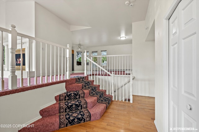 10931 Adanak Cir, Eagle River, AK 99577 - staircase featuring wood finished floors, a ceiling fan, and baseboards