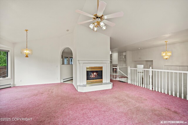 10931 Adanak Cir, Eagle River, AK 99577 - unfurnished living room featuring baseboard heating, carpet floors, a ceiling fan, a chandelier, and arched walkways