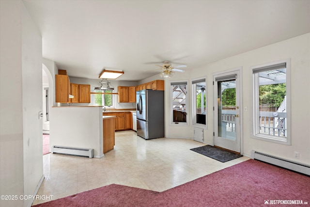 10931 Adanak Cir, Eagle River, AK 99577 - kitchen with stainless steel refrigerator with ice dispenser, baseboard heating, ceiling fan, and arched walkways