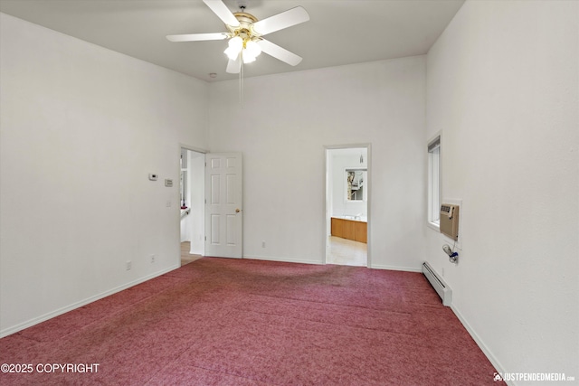 10931 Adanak Cir, Eagle River, AK 99577 - unfurnished bedroom with a baseboard heating unit, carpet floors, baseboards, ensuite bathroom, and a towering ceiling