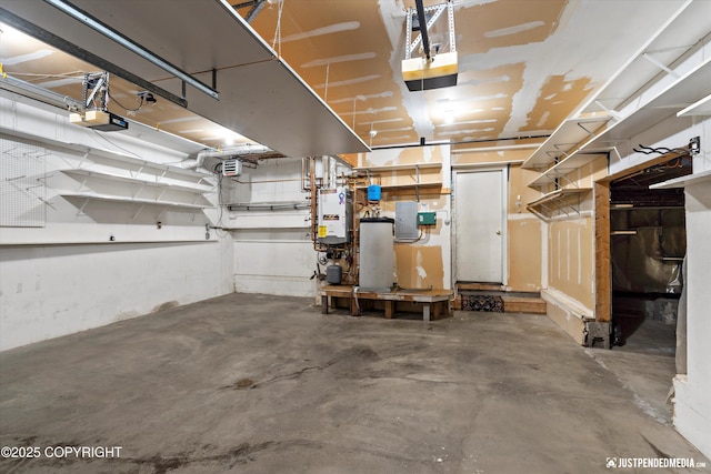 10931 Adanak Cir, Eagle River, AK 99577 - garage with a garage door opener and tankless water heater