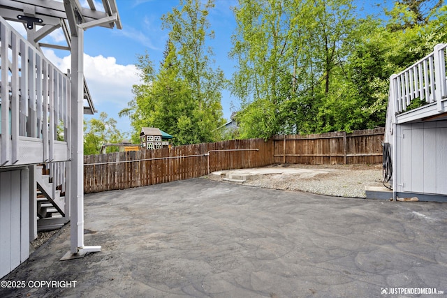 10931 Adanak Cir, Eagle River, AK 99577 - fenced backyard with stairway and a patio area