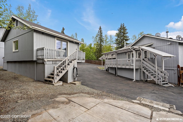 10931 Adanak Cir, Eagle River, AK 99577 - view of property exterior featuring stairs and a deck