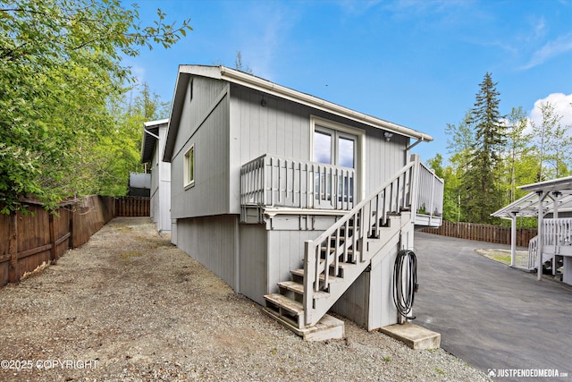 10931 Adanak Cir, Eagle River, AK 99577 - view of front facade with stairs and a fenced backyard