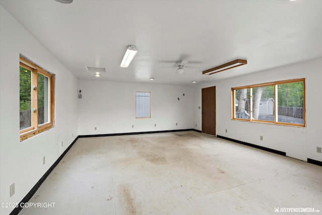 10931 Adanak Cir, Eagle River, AK 99577 - empty room featuring healthy amount of natural light, concrete floors, baseboards, and ceiling fan