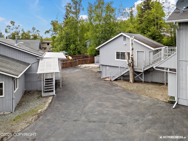 10931 Adanak Cir, Eagle River, AK 99577 - view of side of property with stairway and roof with shingles
