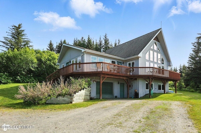 41722 Charlie Dr, Homer, AK 99603 - view of front of house with dirt driveway, a wooden deck, a shingled roof, and a front lawn