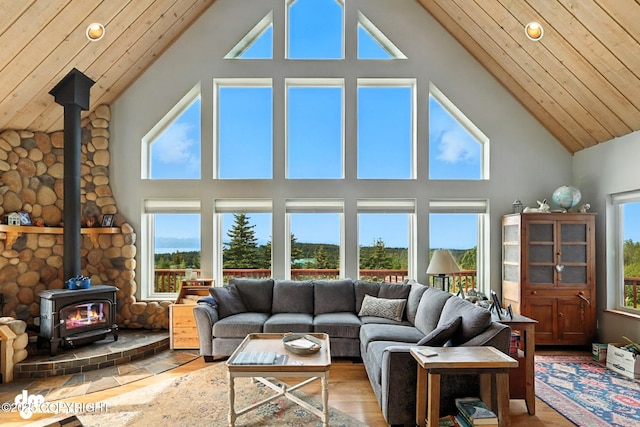 41722 Charlie Dr, Homer, AK 99603 - living area with a wood stove, high vaulted ceiling, plenty of natural light, wood ceiling, and wood finished floors
