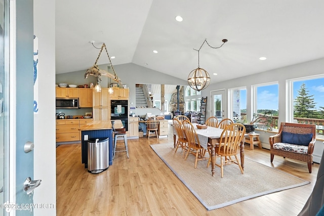 41722 Charlie Dr, Homer, AK 99603 - dining area with a chandelier, light wood-type flooring, vaulted ceiling, and recessed lighting