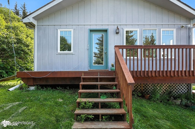 41722 Charlie Dr, Homer, AK 99603 - view of exterior entry featuring a lawn and a wooden deck