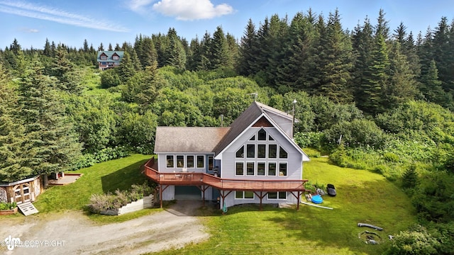 41722 Charlie Dr, Homer, AK 99603 - rear view of house with driveway, a forest view, a carport, and a yard