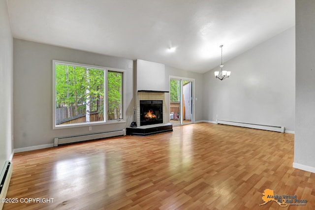 18739 Sarichef Loop, Eagle River, AK 99577 - unfurnished living room with a baseboard heating unit, vaulted ceiling, a chandelier, and light wood-style floors