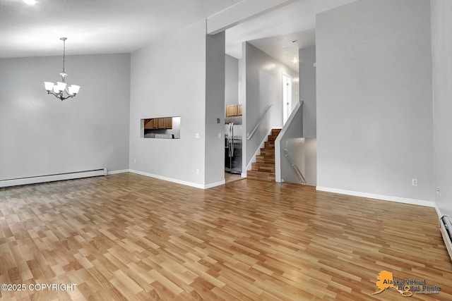 18739 Sarichef Loop, Eagle River, AK 99577 - unfurnished living room featuring baseboard heating, light wood-style floors, a chandelier, baseboards, and lofted ceiling
