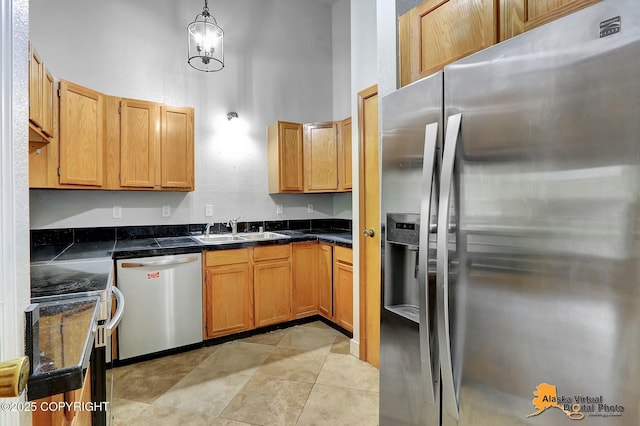 18739 Sarichef Loop, Eagle River, AK 99577 - kitchen featuring appliances with stainless steel finishes, a sink, hanging light fixtures, and a towering ceiling