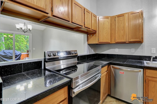 18739 Sarichef Loop, Eagle River, AK 99577 - kitchen with appliances with stainless steel finishes, a chandelier, a sink, and tile countertops
