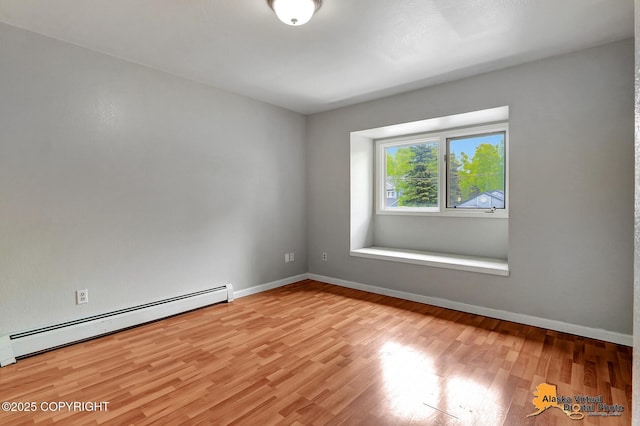 18739 Sarichef Loop, Eagle River, AK 99577 - unfurnished room with baseboard heating, light wood finished floors, and baseboards