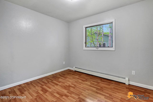 18739 Sarichef Loop, Eagle River, AK 99577 - spare room with a baseboard radiator, light wood-style floors, and baseboards
