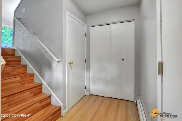 18739 Sarichef Loop, Eagle River, AK 99577 - staircase featuring wood finished floors and a baseboard radiator