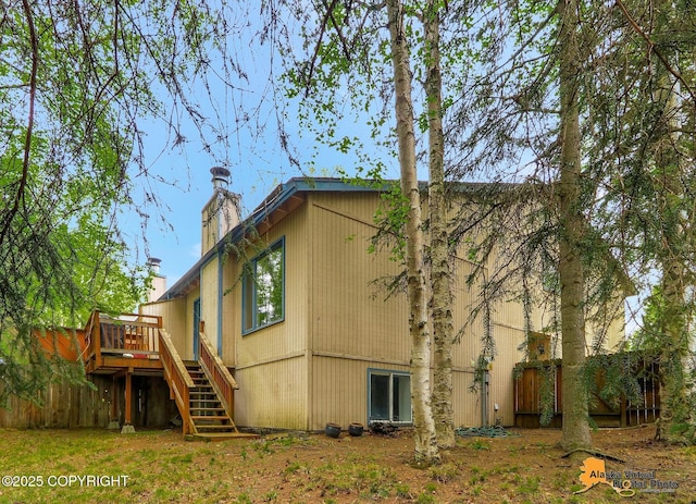18739 Sarichef Loop, Eagle River, AK 99577 - view of home's exterior with stairs, a wooden deck, and a chimney