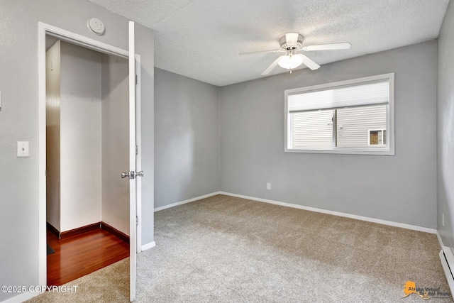 7075 Weimer Rd # 6, Anchorage, AK 99502 - unfurnished bedroom with carpet flooring, a textured ceiling, baseboards, and a baseboard radiator