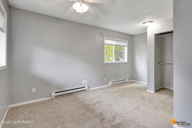 7075 Weimer Rd # 6, Anchorage, AK 99502 - unfurnished bedroom with a baseboard radiator, carpet, a textured ceiling, baseboards, and a closet