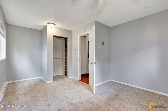 7075 Weimer Rd # 6, Anchorage, AK 99502 - unfurnished bedroom featuring a textured ceiling, a closet, carpet flooring, and baseboards