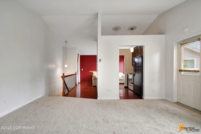 7075 Weimer Rd # 6, Anchorage, AK 99502 - carpeted bedroom featuring freestanding refrigerator, lofted ceiling, and baseboards