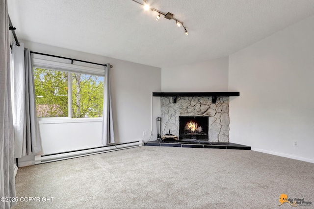 7075 Weimer Rd # 6, Anchorage, AK 99502 - unfurnished living room with a baseboard heating unit, carpet floors, a textured ceiling, a stone fireplace, and rail lighting