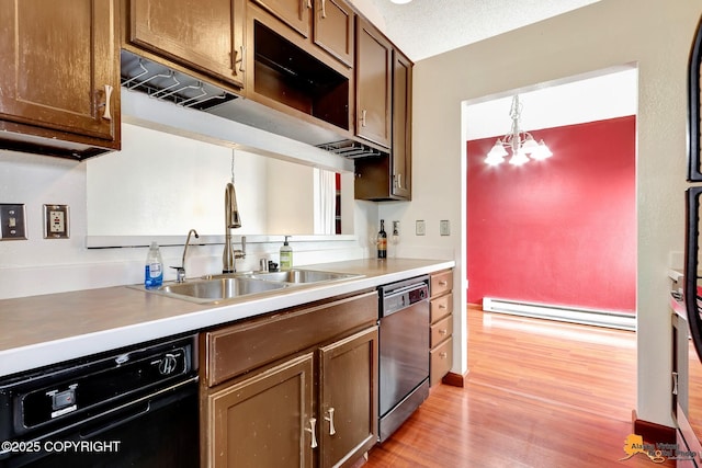 7075 Weimer Rd # 6, Anchorage, AK 99502 - kitchen featuring dishwashing machine, a baseboard heating unit, a sink, light wood-style floors, and black dishwasher