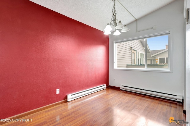 7075 Weimer Rd # 6, Anchorage, AK 99502 - unfurnished room with a baseboard radiator, lofted ceiling, a chandelier, wood finished floors, and a textured ceiling