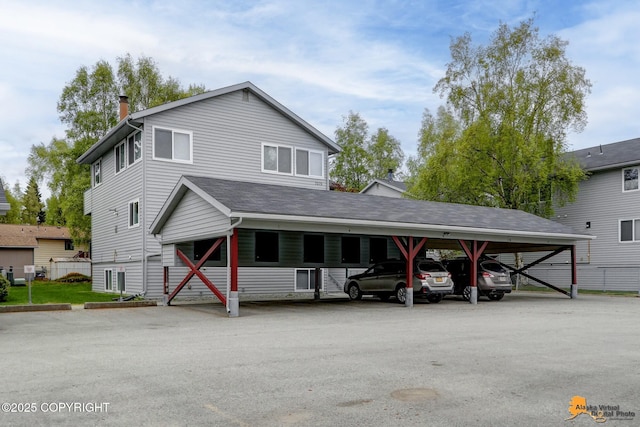 7075 Weimer Rd # 6, Anchorage, AK 99502 - view of front facade featuring covered parking and a chimney