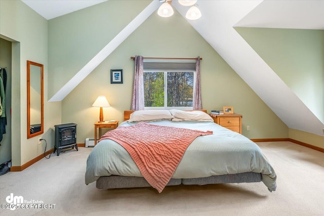 20838 Helluva St, Chugiak, AK 99567 - carpeted bedroom with a wood stove, lofted ceiling, baseboards, and baseboard heating