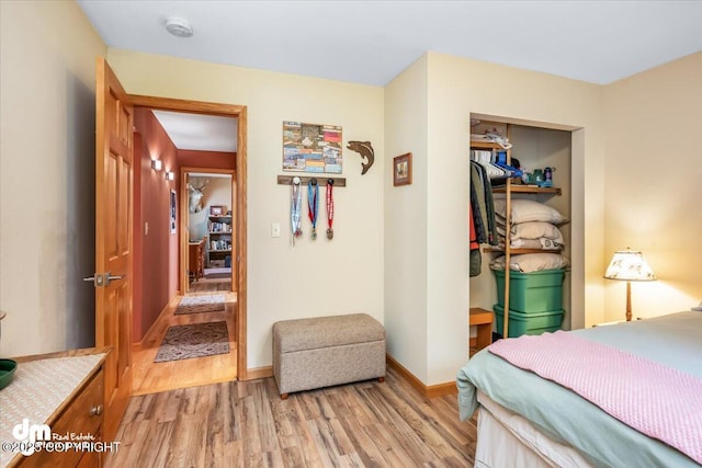 20838 Helluva St, Chugiak, AK 99567 - bedroom featuring light wood-style flooring, a closet, and baseboards