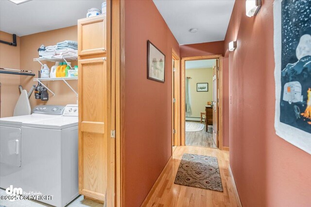 20838 Helluva St, Chugiak, AK 99567 - laundry area featuring light wood-style floors, washing machine and dryer, a baseboard radiator, and baseboards