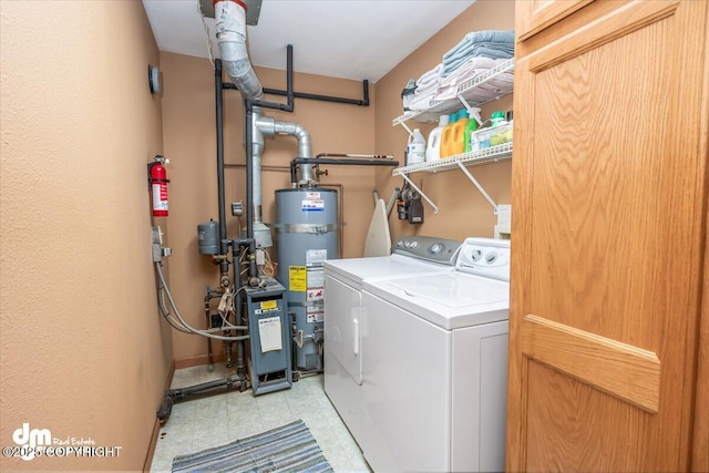 20838 Helluva St, Chugiak, AK 99567 - laundry room featuring secured water heater, washing machine and dryer, baseboards, and a heating unit