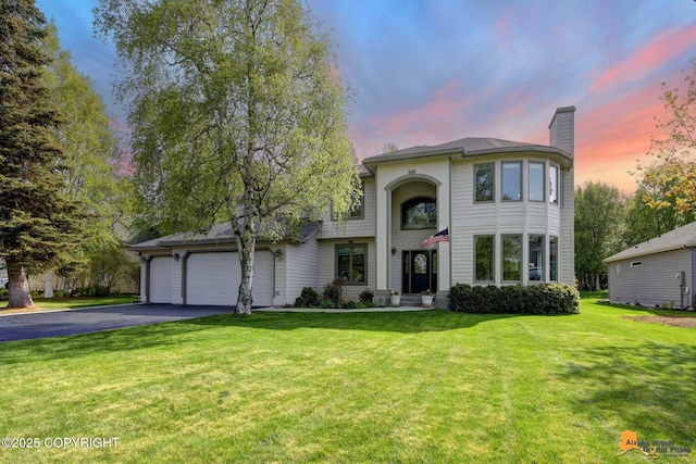 740 Botanical Heights Cir, Anchorage, AK 99515 - traditional-style house with a chimney, driveway, a lawn, and an attached garage